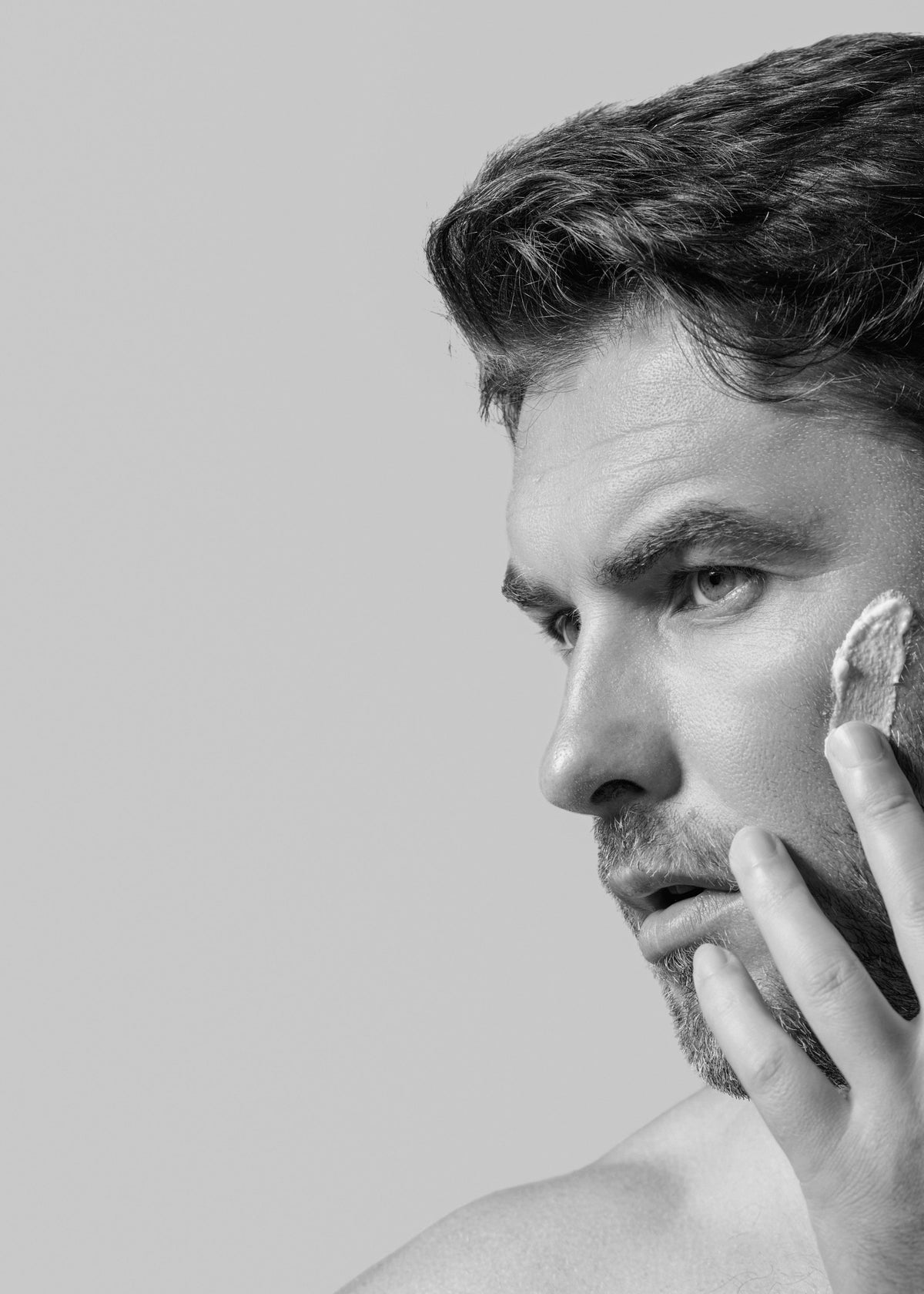 Man applying moisturiser to his face
